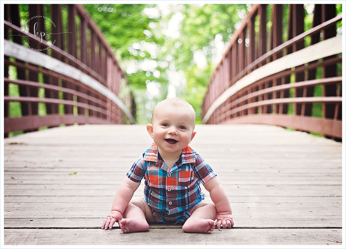 adorable 6 month old boy photo session in green bay wisconsin park sitting on bridge