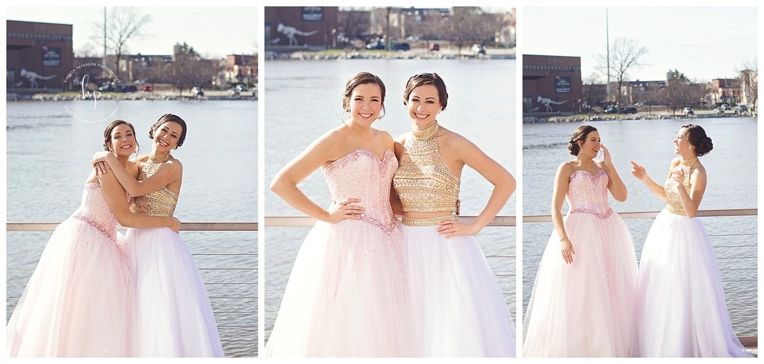 best friends in prom dresses posing on city deck in green bay wisconsin boardwalk sunny day