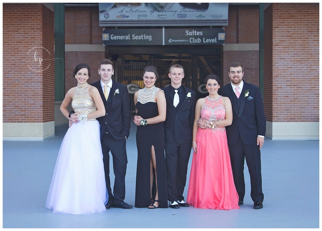 couples posing for prom pictures at lambeau field in green bay wisconsin